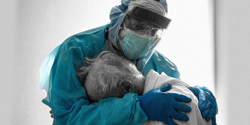 Image: A doctor hugs and comforts a patient in the hospital