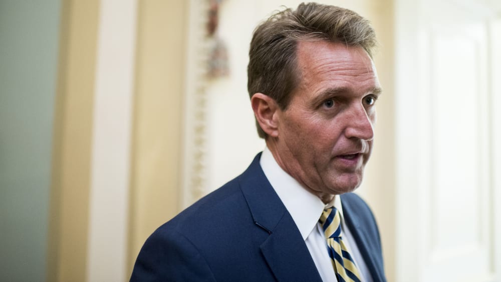 Sen. Jeff Flake, R-Ariz., stops to speak with a reporter as he arrives for the Senate Republicans' policy luncheon, May 12, 2015. (Photo By Bill Clark/CQ Roll Call/AP)