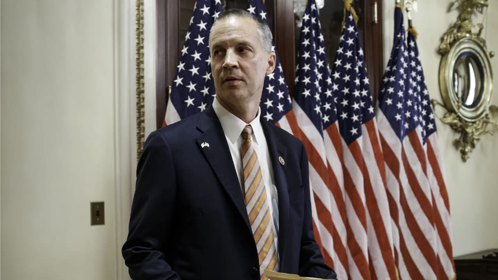 Rep. Curt Clawson, R-Fla., carries a Bible for as ceremonial swearing-in with Speaker of the House John Boehner, R-Ohio, at the Capitol in Washington, Wednesday, June 25, 2014.