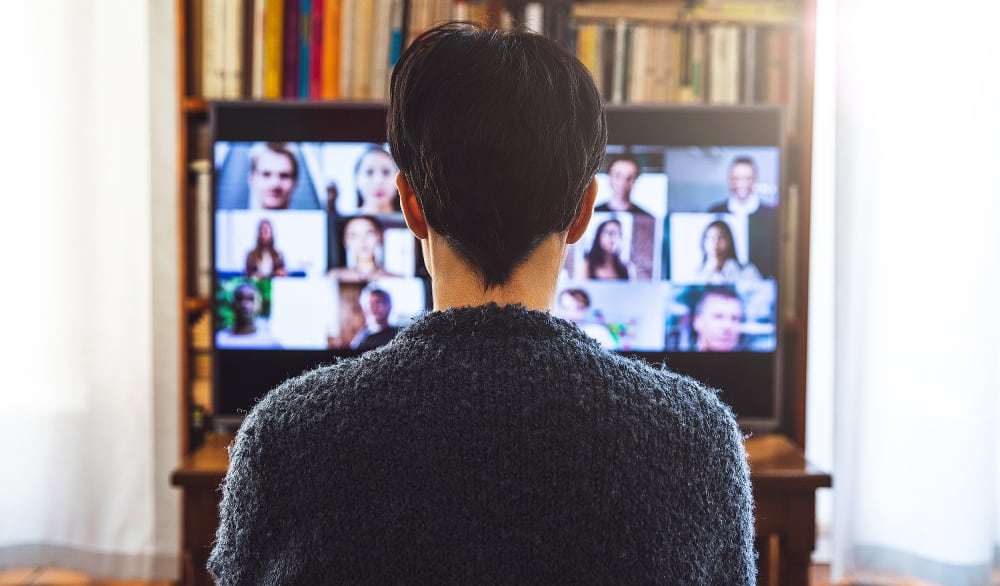 Woman in front of a device screen in video conference for work.