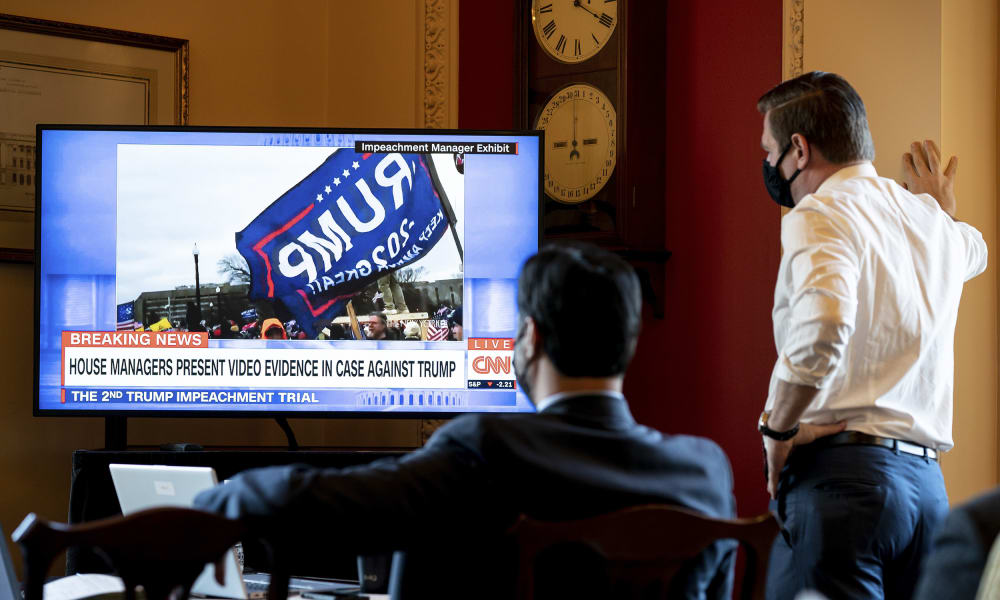 Image: House impeachment managers watch the first day of proceedings in the Senate trial of former President Donald Trump from a room in the Capitol in Washington