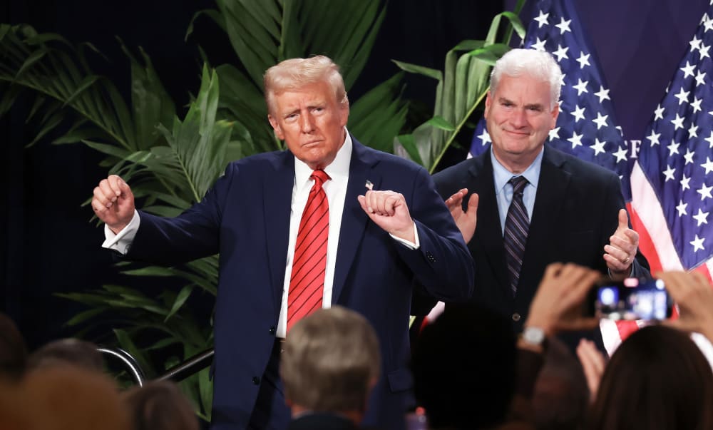 U.S. President Donald Trump dances as House Majority Whip Tom Emmer applauds on Jan. 27, 2025 in Doral, FL.