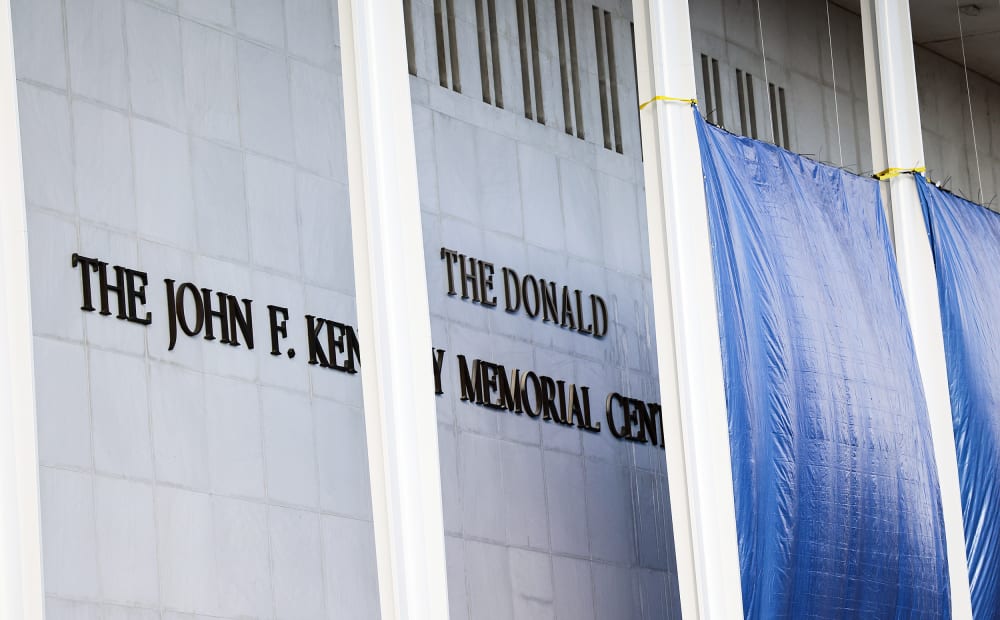 Workers adjust the name of the “John F. Kennedy Memorial Center for the Performing Arts" on Dec. 19, 2025 in Washington, D.C.