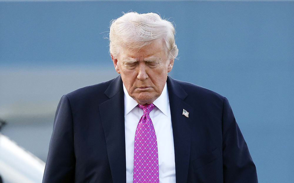 U.S. President Donald Trump looking down.