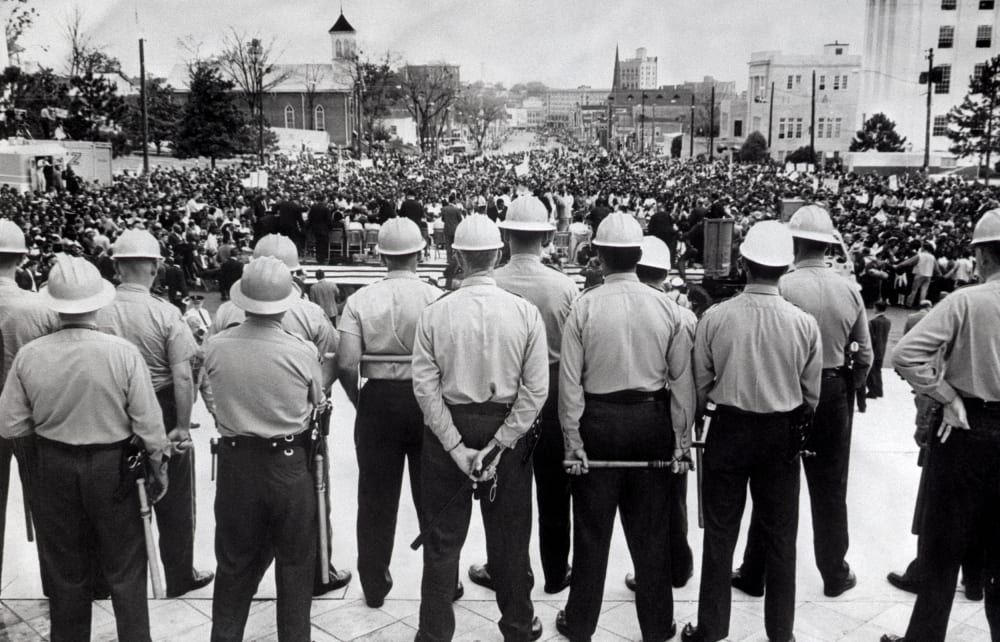 Image: State conservation agents, wielding nightsticks, watch as civil rights marchers arrive at the Alabama State Capitol in Montgomery, Ala., in 1965.