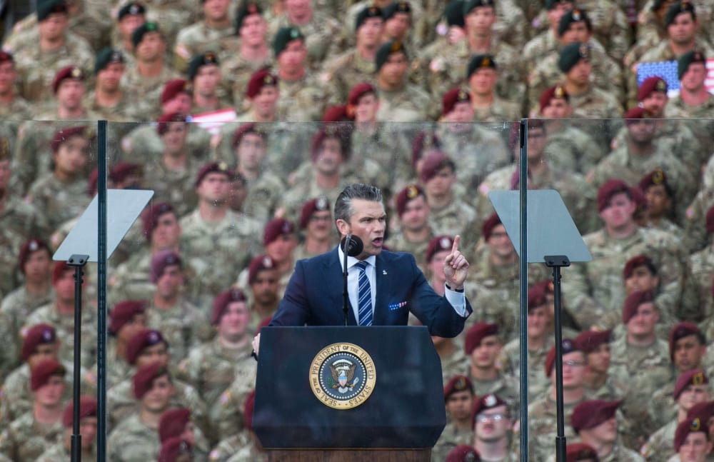 Pete Hegseth in front of a crowd of soldiers.