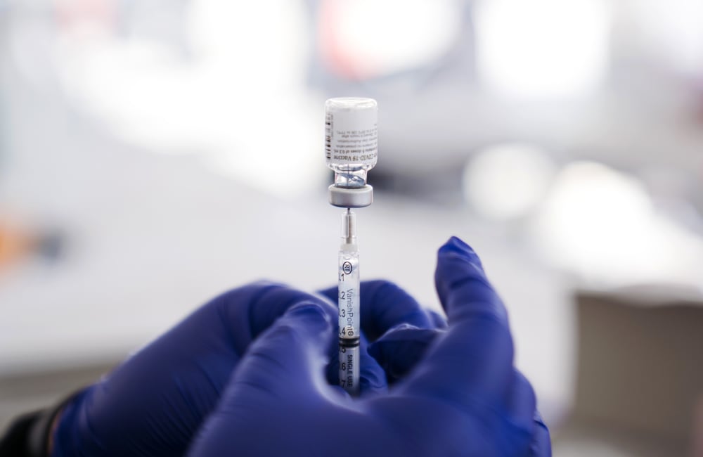 A healthcare worker prepares a dose of the Pfizer-BioNTech Covid-19 Vaccine at a mass vaccination site at The Forum arena in Inglewood, Calif., on Feb. 26, 2021.