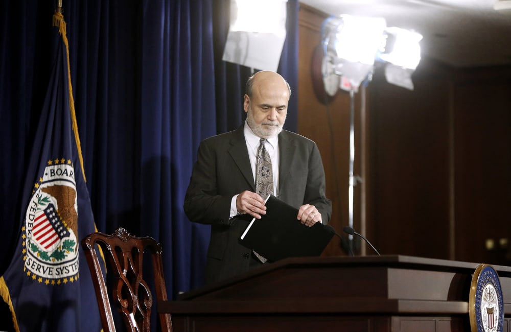 U.S. Federal Reserve Chairman Ben Bernanke takes his seat for a news conference at the Federal Reserve Bank headquarters in Washington, Dec. 18, 2013.