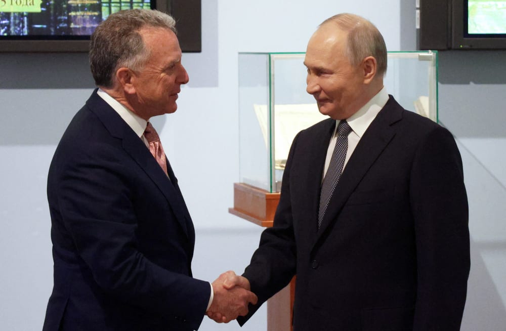 Russia's President Vladimir Putin shakes hands with US President Donald Trump's envoy Steve Witkoff.