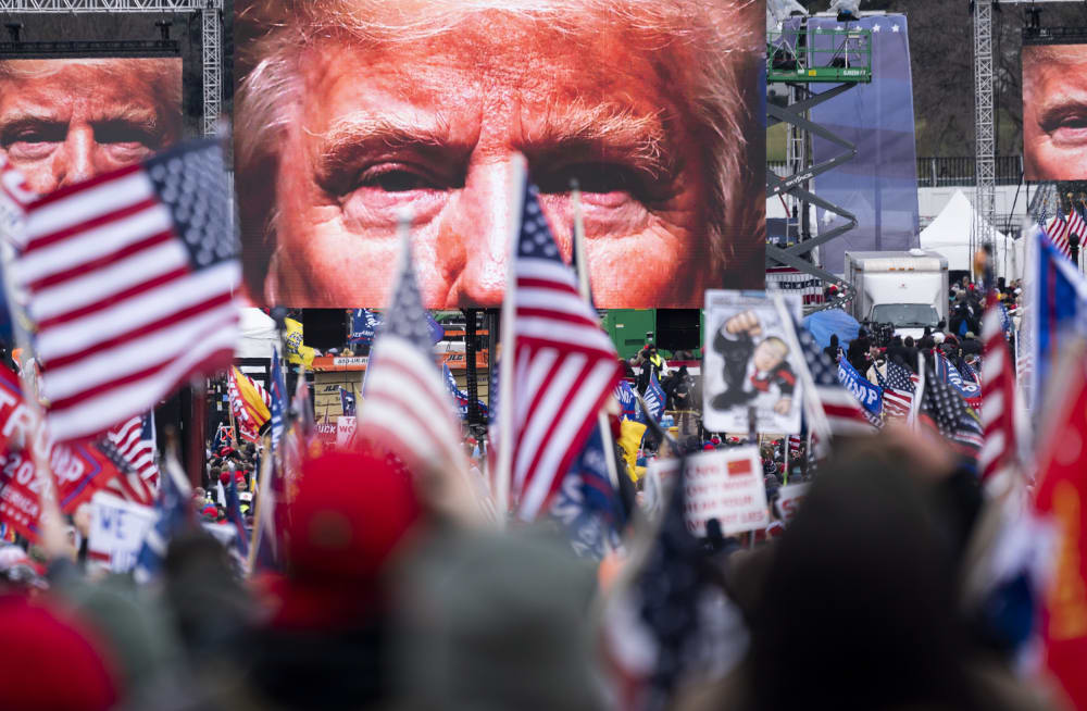 President Trump's closeup photo seen on video screens in front of a crowd at a rally.