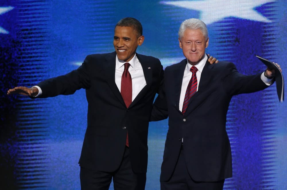 U.S. President Barack Obama joins former President Bill Clinton onstage after Clinton nominated Obama for re-election during the second session of the Democratic National Convention September 5.