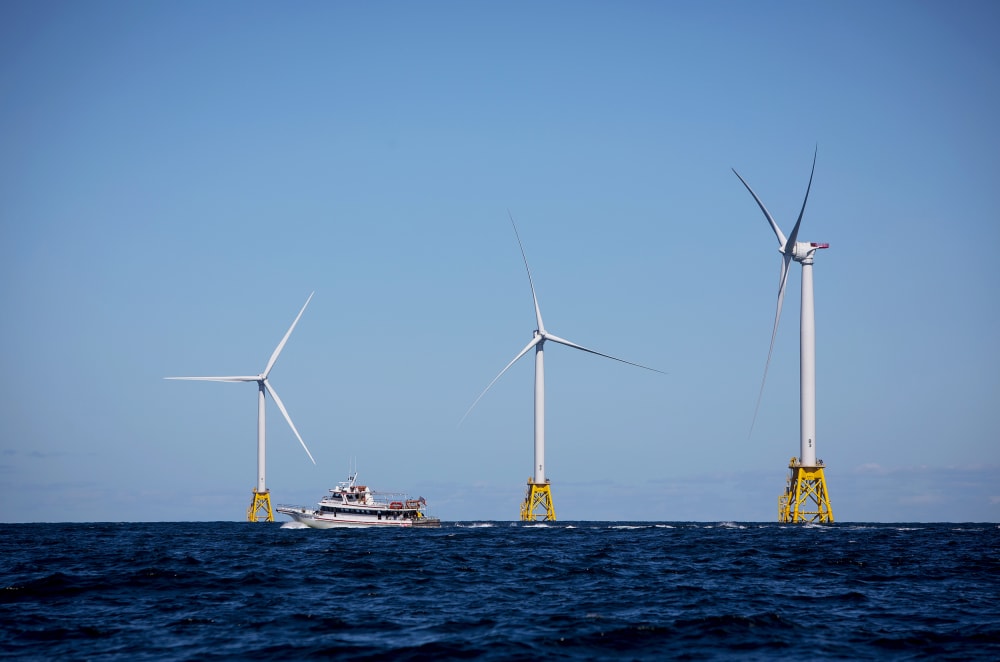 A boat passes in front of the Ørsted Block Island Wind Farm off Block Island, R.I., on Sept, 14, 2016.