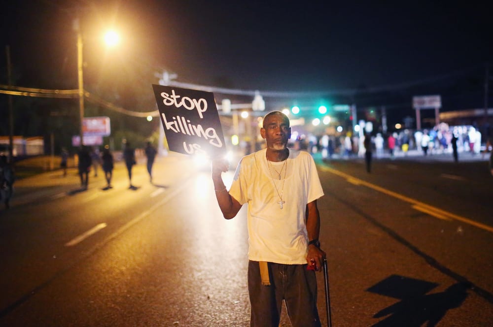 Frederick Scott protests the killing of teenager Michael Brown on Aug. 18, 2014 in Ferguson, Mo.
