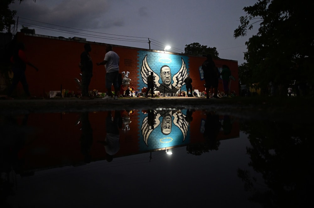 Image: People stand in front of a mural of George Floyd in Houston, Texas