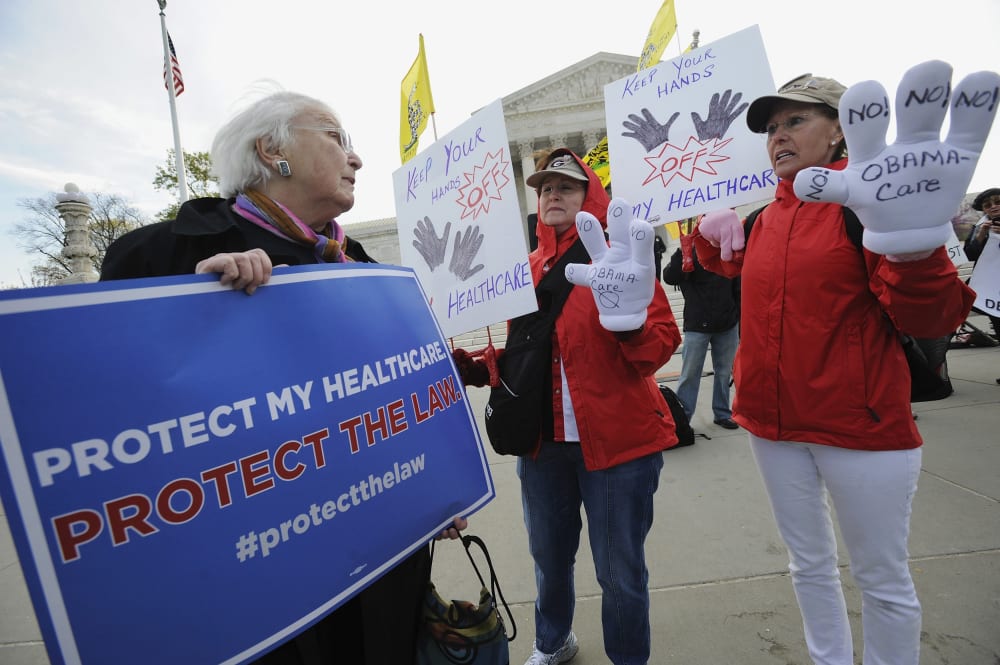 "Obamacare" supporter Margot Smith (L) of California pleads her case with legislation opponents Judy Burel (2nd R) and Janis Haddon, both of Georgia, at the U.S. Supreme Court in Washington, March 28, 2012.