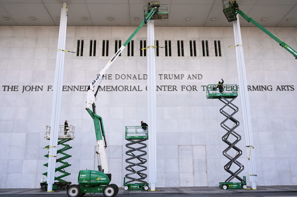 Construction people unveil new signage for the newly renamed The Donald J. Trump and The John F. Kennedy Memorial Center For The Performing Arts.