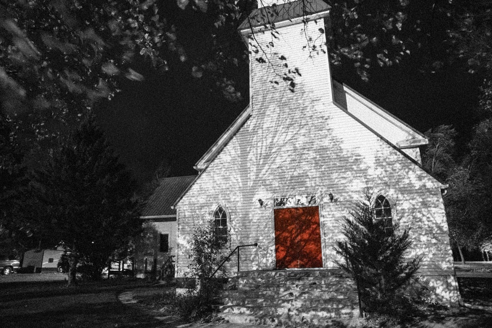 Image: A white church with a red door
