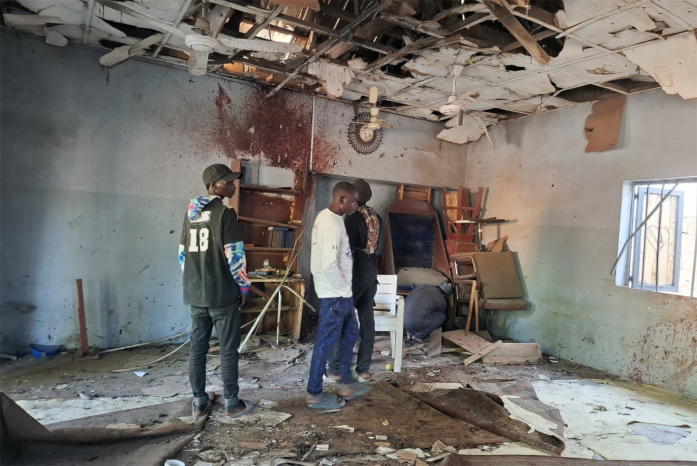 People inspect the scene of a deadly bomb explosion inside a mosque on Dec. 25 in Maiduguri, Nigeria.