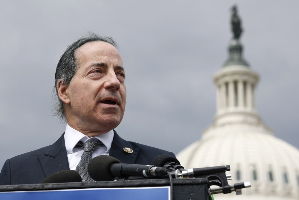 Jamie Raskin speaks at a podium in front of the US Capitol.