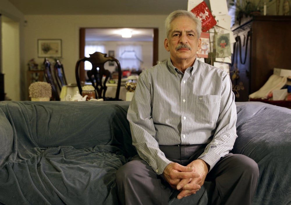 In this Jan. 10, 2014 photo, Stan Osnowitz poses in his living room in Baltimore. Osnowitz, 67, lost his state unemployment benefits of $430 a week in December.