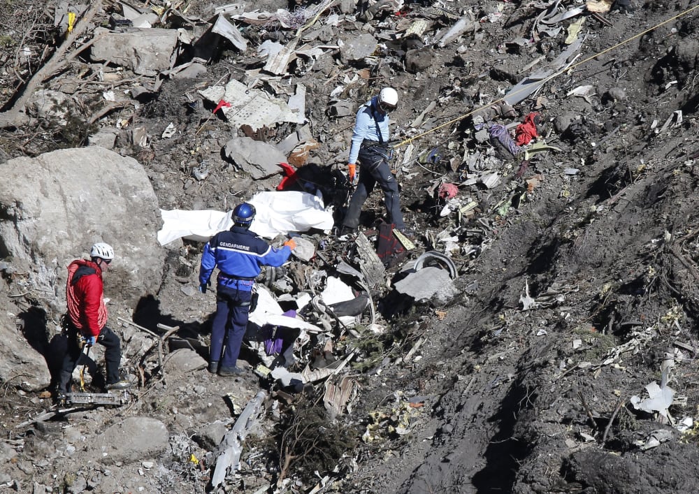 Search and rescue workers make their way through debris at the crash site of the Germanwings Airbus A320 that crashed in the French Alps, above the town of Seyne-les-Alpes, southeastern France on March 26, 2015.