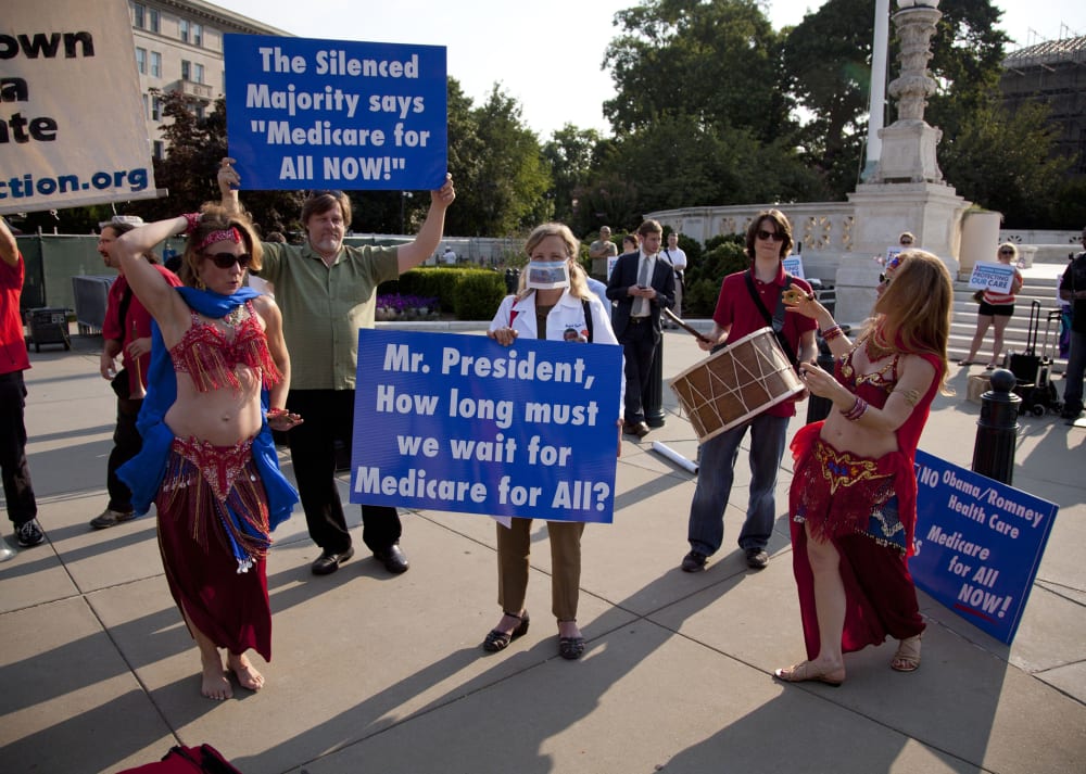 A group of belly dancers in favor of Medicare for all perform outside the Supreme Court in Washington, Thursday, June 28, 2012.