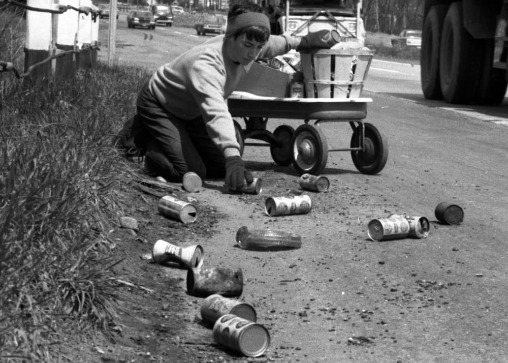 On the first Earth Day, Terry Seuss, 14, cleans up soda and beer cans on Route 17 in Hohokus, N.J., April 22, 1970. (Photo by Jerry Kinstle/NY Daily News/Getty)