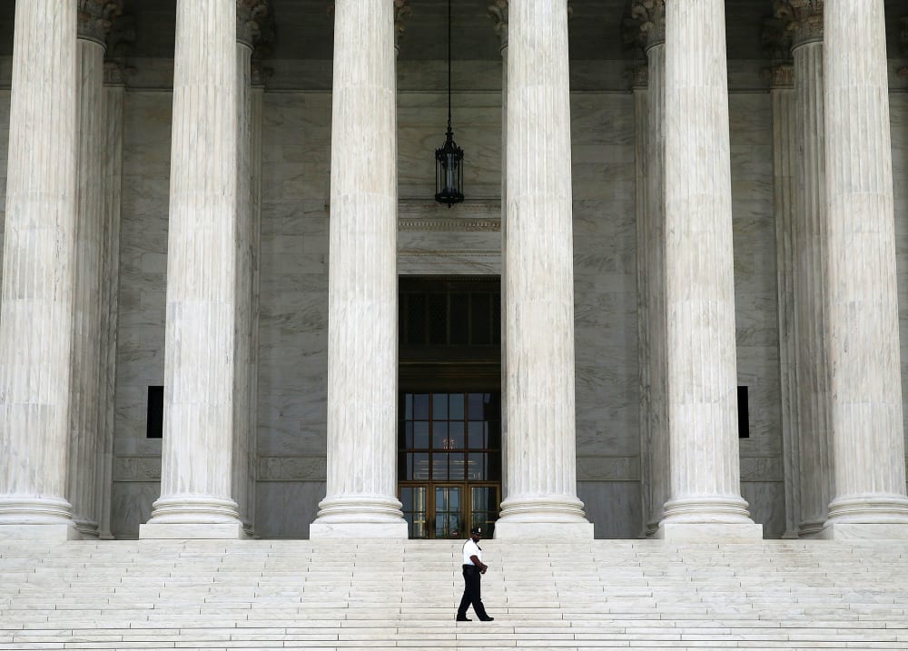 A guard stands outside the U.S. Supreme Court , on June 9, 2014 in Washington, DC.