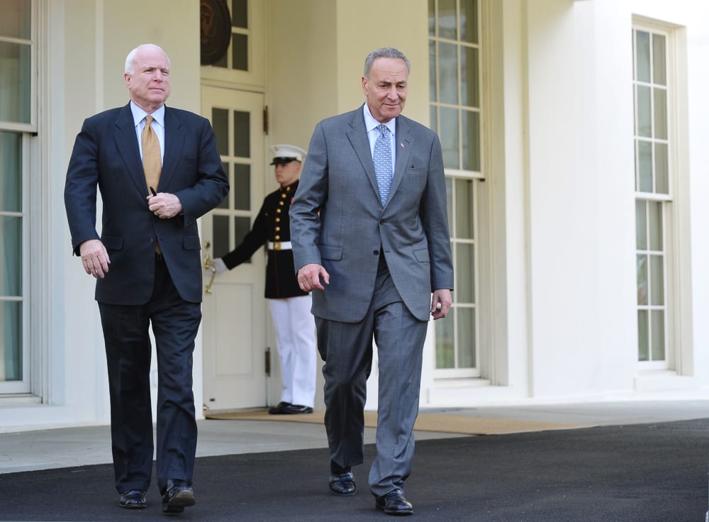 Senator Chuck Schumer (L), D-NY, and Senator John McCain, R-AZ, make their way to speak to reporters outside of the West Wing following a meeting with US President Barack Obama to brief him on the draft of a bipartisan immigration reform bill at the...