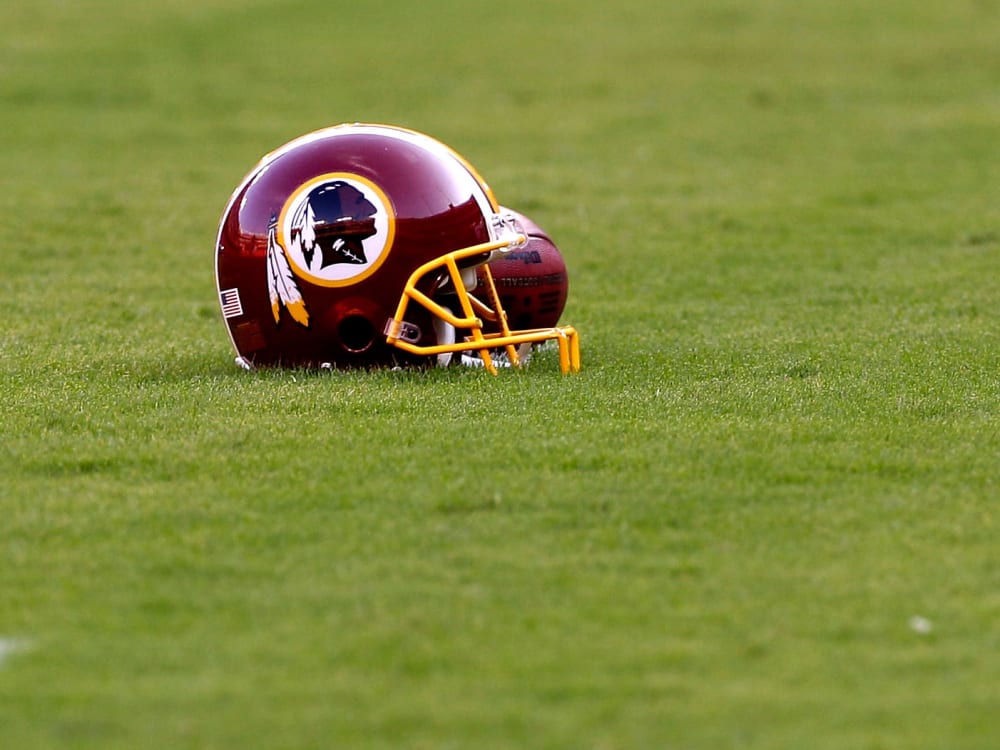 File Photo: A Washington Redskins helmet sits on the field before the start of the preseason game between the Tampa Bay Buccaneers and Redskins at FedExField on September 1, 2011 in Landover, Maryland. (Photo by Rob Carr/Getty Images, File)