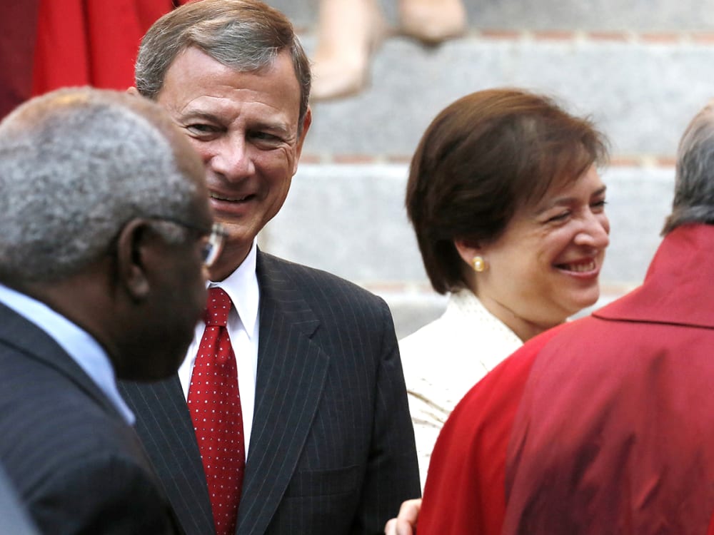 U.S. Supreme Court Justice Clarence Thomas (back to camera), Chief Justice John Roberts and Justice Elena Kagan
