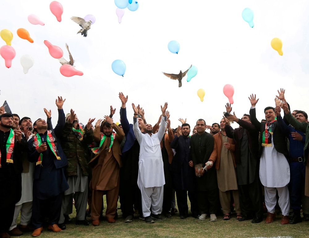 Image: Afghan men celebrate in anticipation of the U.S-Taliban agreement to allow a U.S. troop reduction and a permanent ceasefire, in Jalalabad