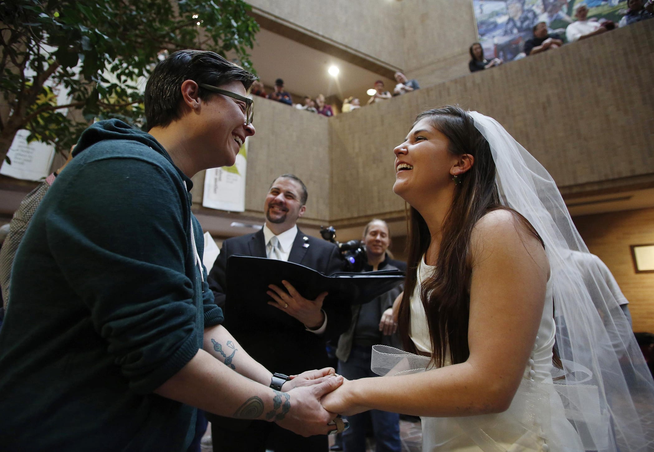 Jax Collins (L) and Heather Collins get married at the Salt Lake County Government Building in Salt Lake City, Utah, December 23, 2013.