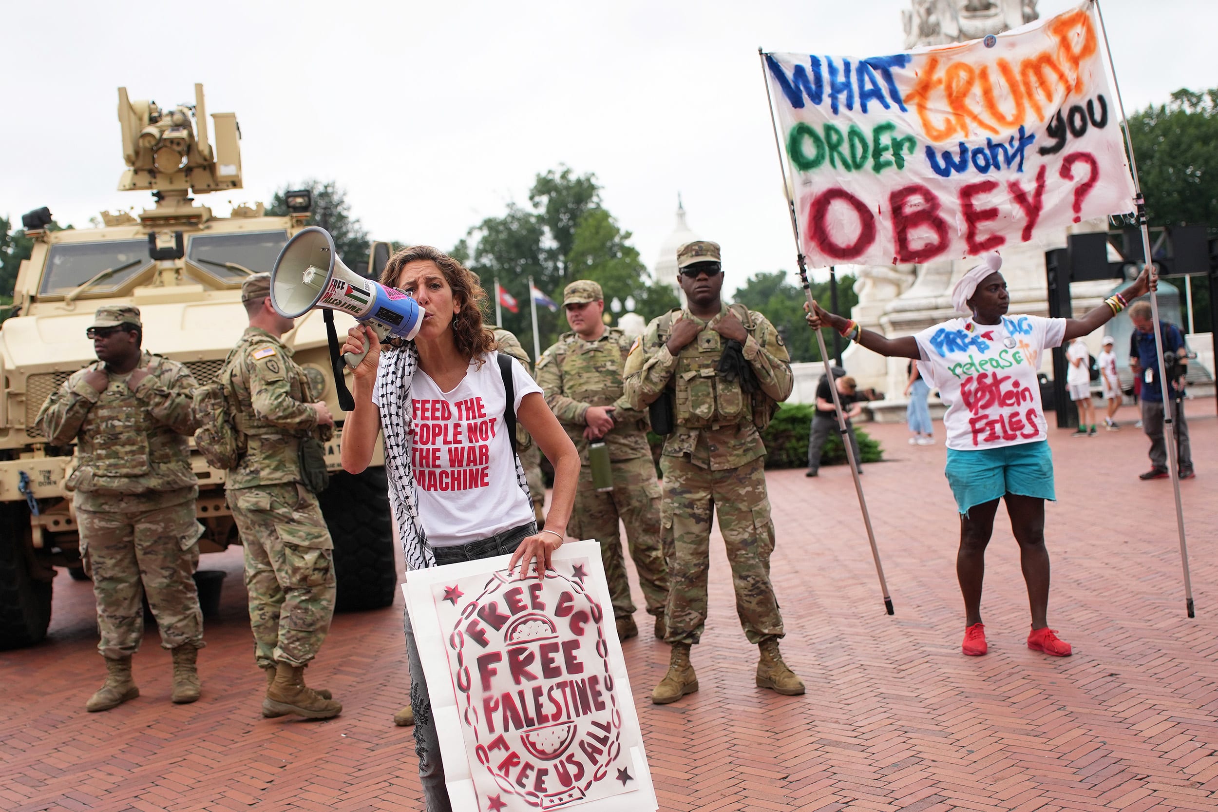 Protesters demonstrate near members of the National Guard in Washington, D.C.