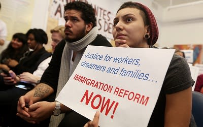 Undocumented immigrant Katherine Taberes, originally from Colombia, watches President Barack Obama's speech on immigration on January 29, 2013. (Photo by Mario Tama/Getty Images)