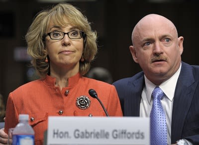 Former Arizona Rep. Gabrielle Giffords sits with her husband Mark Kelly, on Jan. 30, 2013, and gives an opening statement before the Senate Judiciary Committee hearing on gun violence. (Photo by Susan Walsh/AP Photo)