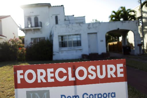 A foreclosure sale sign sits in front of a house in Miami Beach, Florida in 2009. REUTERS/Carlos Barria/Files (UNITED STATES - Tags: BUSINESS REAL ESTATE)