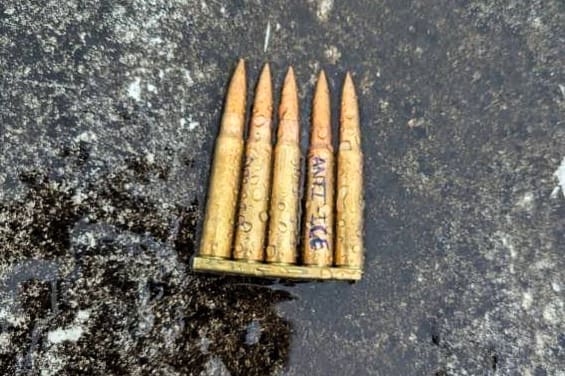 Bullets on the ground with "Anti-ICE" written on one.