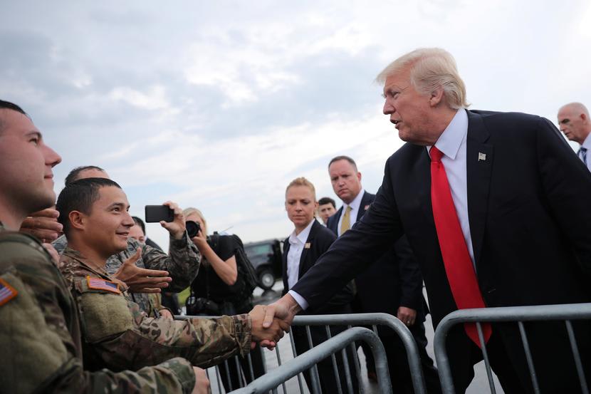 Image: U.S. President Donald Trump greets members of the military as he arrives at Raleigh County Memorial Airport in Beaver, West Virginia, U.S.