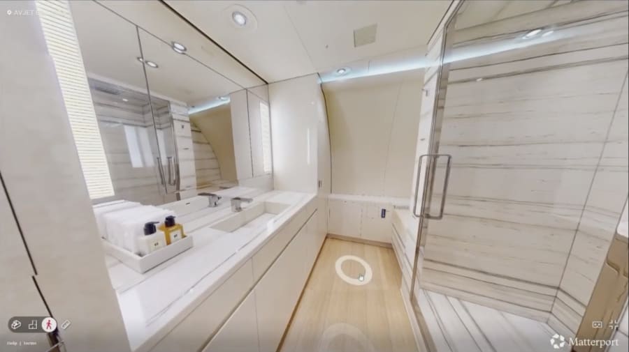 A bathroom, which includes a shower, on the plane.