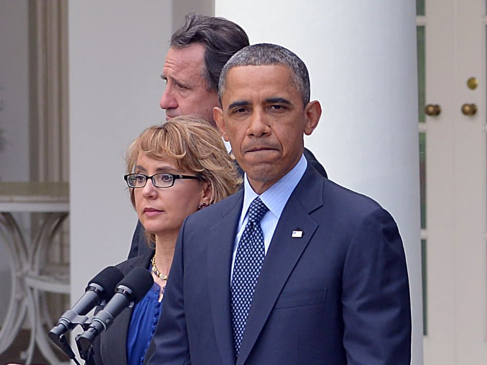 US President Barack Obama, accompanied by former lawmaker Gabrielle Giffords (L), speaks on gun control and the vote at the US Senate on April 17, 2013, in the Rose Garden of the White House (Photo by Mandel Ngan/AFP/Getty Images)