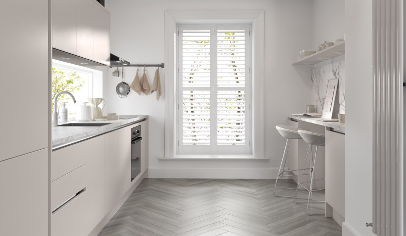 Hero shot of the Linea Kitchen in Cashmere Silk featuring under cabinet lighting, stool seating and herringbone flooring