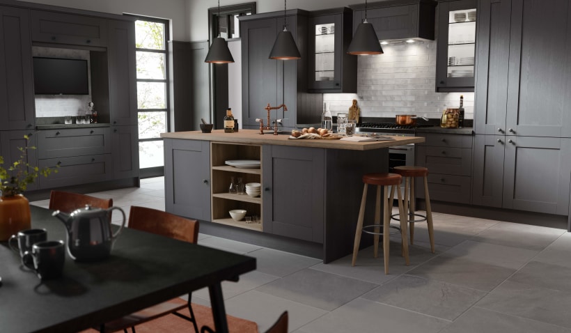 Hero shot of the Shaker Forest Kitchen in Alchemy featuring a kitchen island, stools and pendent lighting