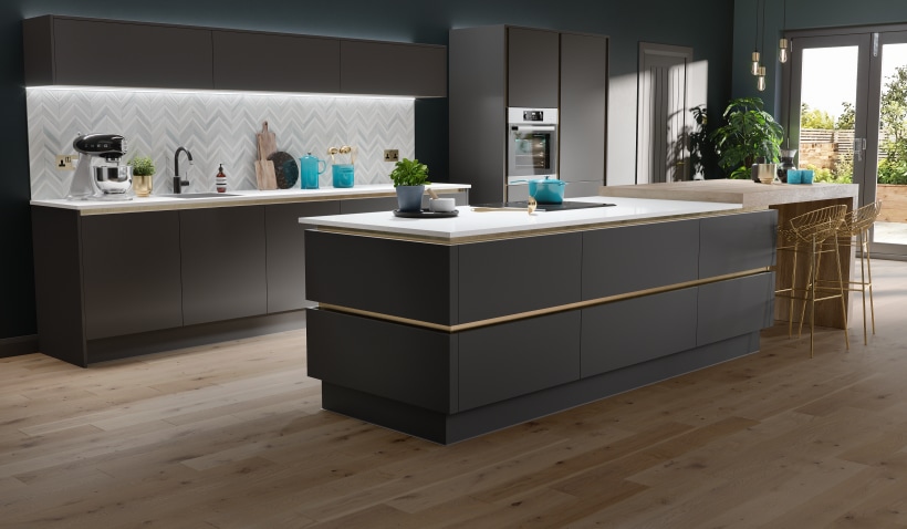Hero shot of the Milano Ultra Kitchen in Pencil Grey featuring kitchen island with gold profiles and handleless drawers and under cabinet lighting