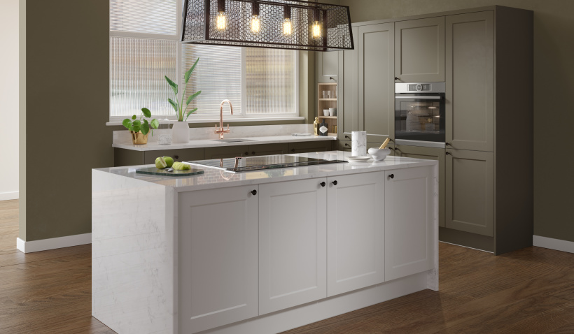 Hero shot of the Shaker Chelsea Ermine Kitchen in Olive Green &amp; Pillow featuring island with hob and overhead lighting