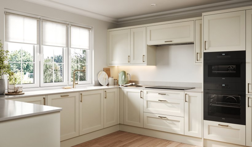 Hero shot of the U-shaped Shaker Denver Ermine Kitchen in Cream Matt featuring built-in double ovens and bar handles