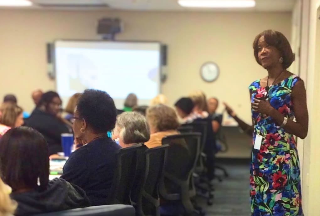 Dr. Leslie speaking in front of a group of people