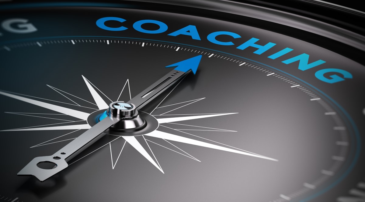 A compass illustrating the time for coaching