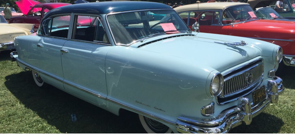 What pale blue older style (50's, 60's, or 70's) convertible