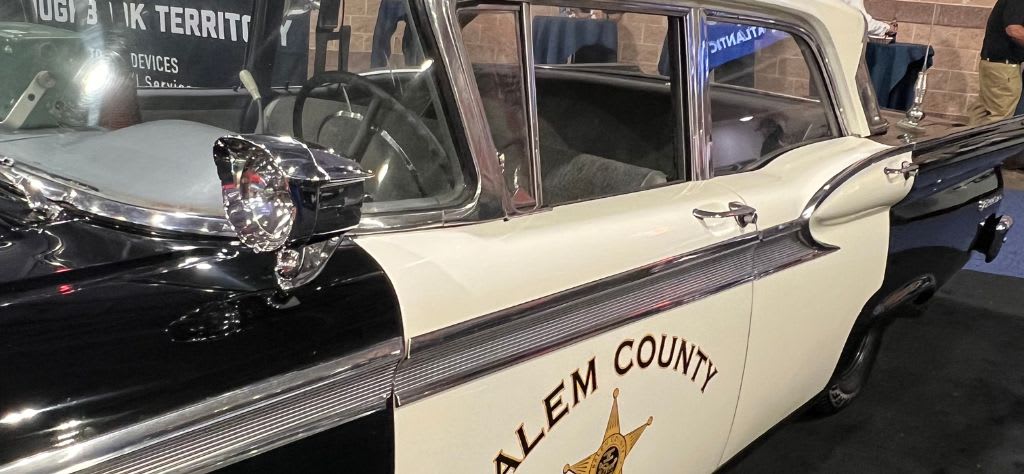 The Police Security Expo showcases classic police cars from various precincts.